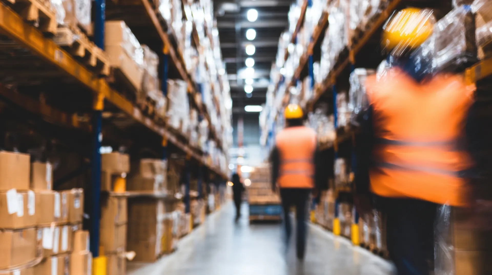 Busy warehouse environment with workers organizing packages during the day 
